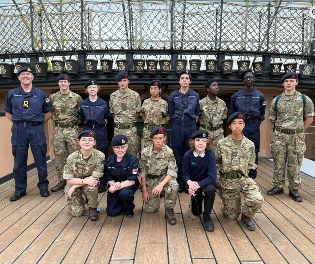 Cadets arranged in rows on deck of the HMS Victory