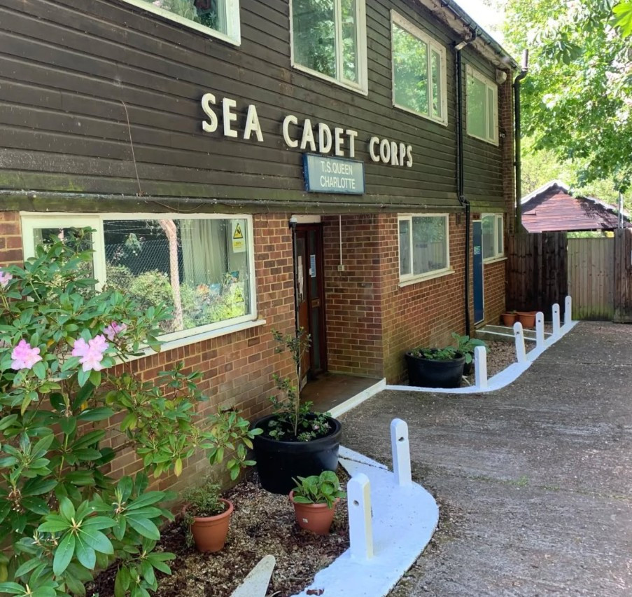 Photo showing the main entrance of the unit, with lovely green planters and freshly painted edges.