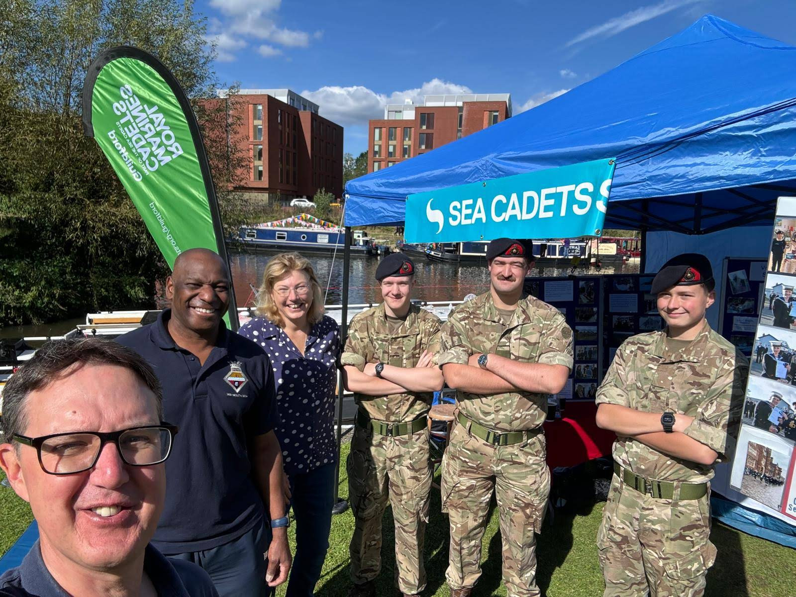 A line of happy cadet volunteers, Recruiting now! Adult volunteers wanted.