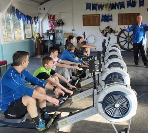 a row of cadets on rowing machines from the last rowathon event.