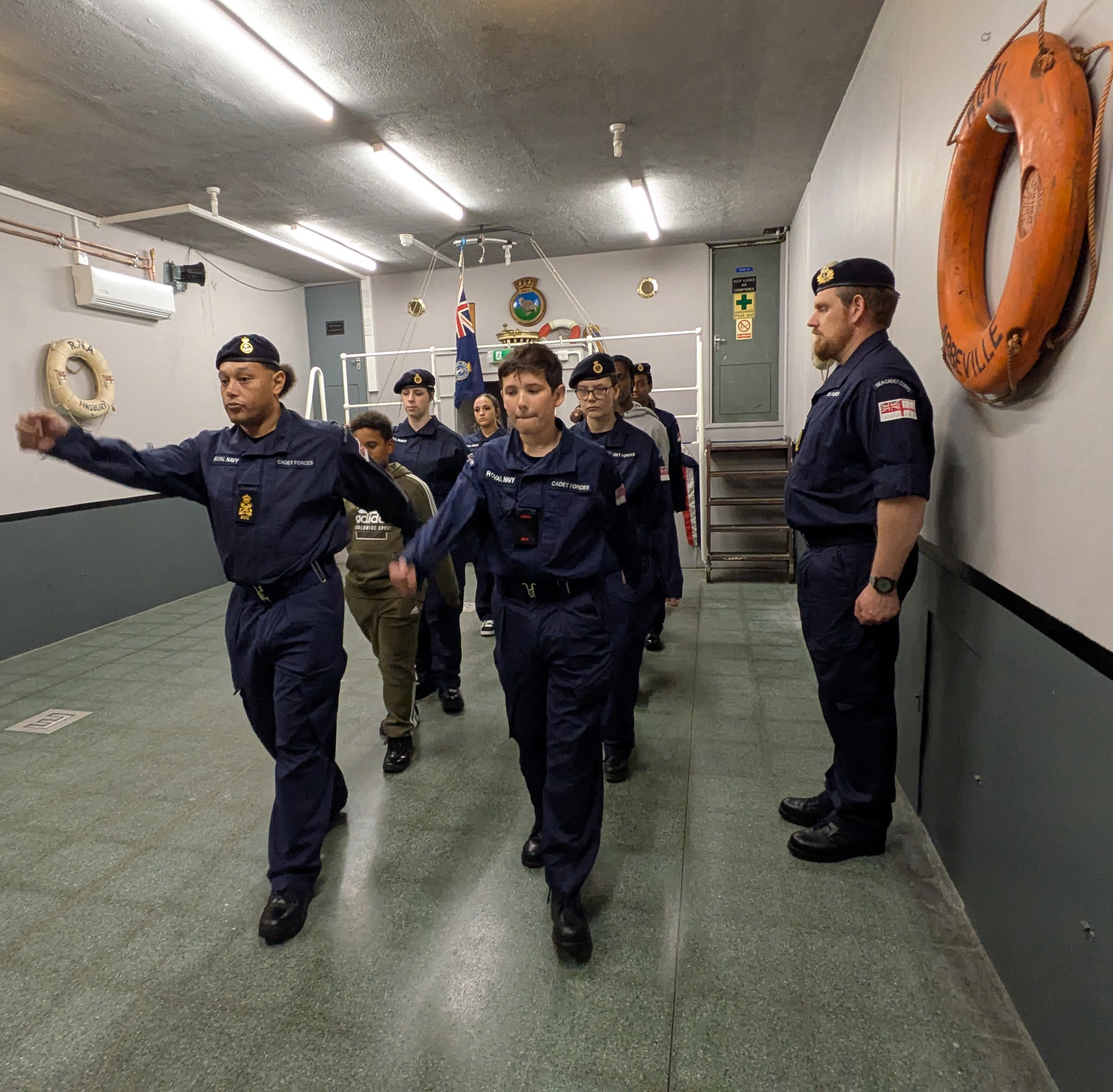 Cadets practicing marching on the main deck of TS Quail, Islington Sea Cadets headquarters.