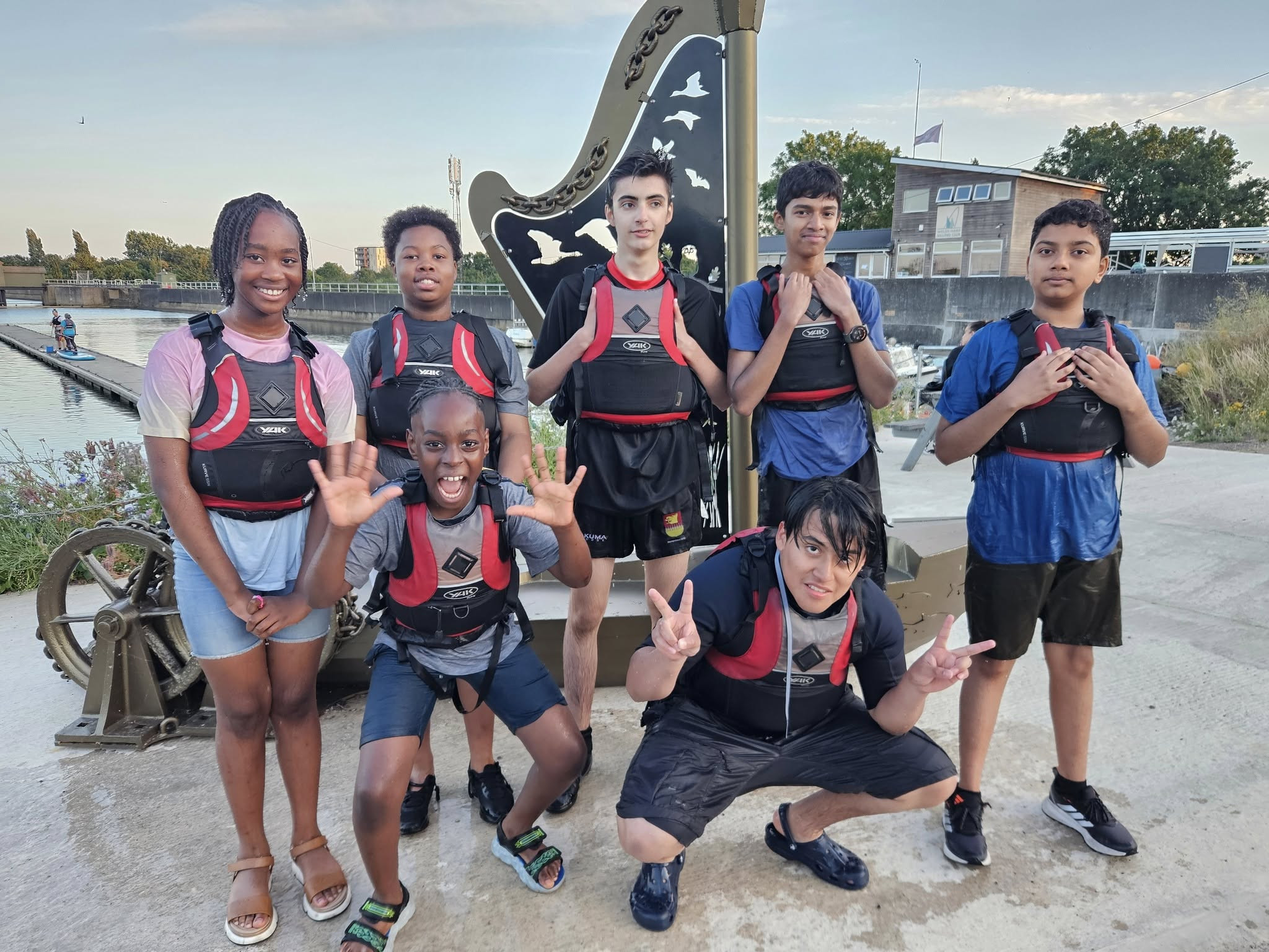 Photo showing cadets in buoyancy aids smiling at the camera after being on the water.