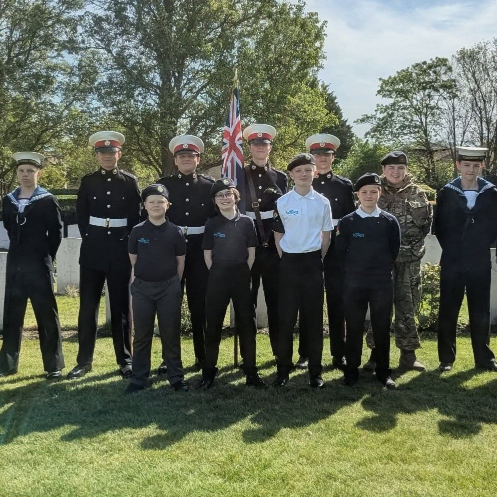 The Cadets and Adult Volunteers of Sea Cadets Cambridge stood in front of war graves following the ANZAC Remembrance Service.