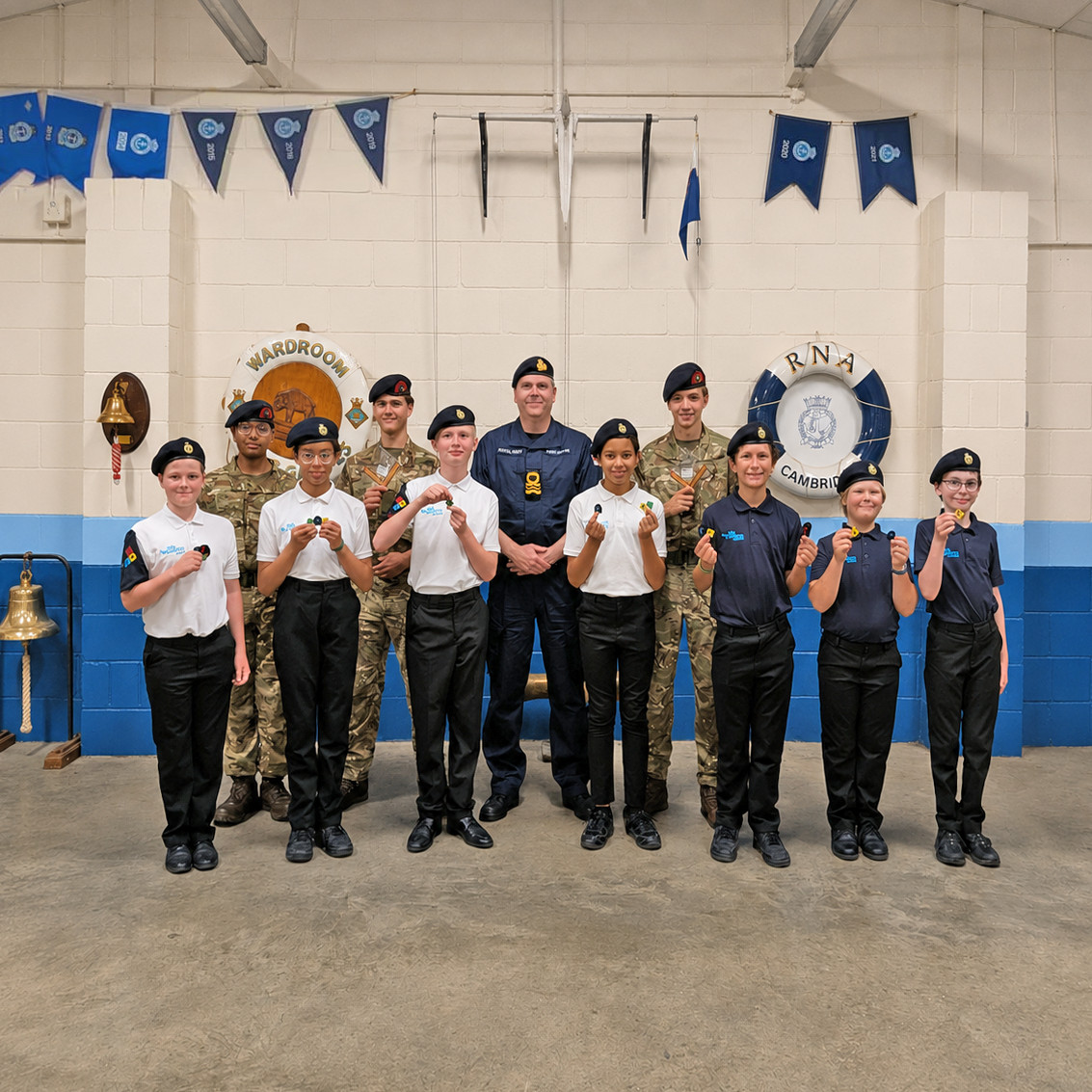 Lieutenant Commander Janner-Burgess surrounded by the Cadets receiving awards at the Unit Review Visit.