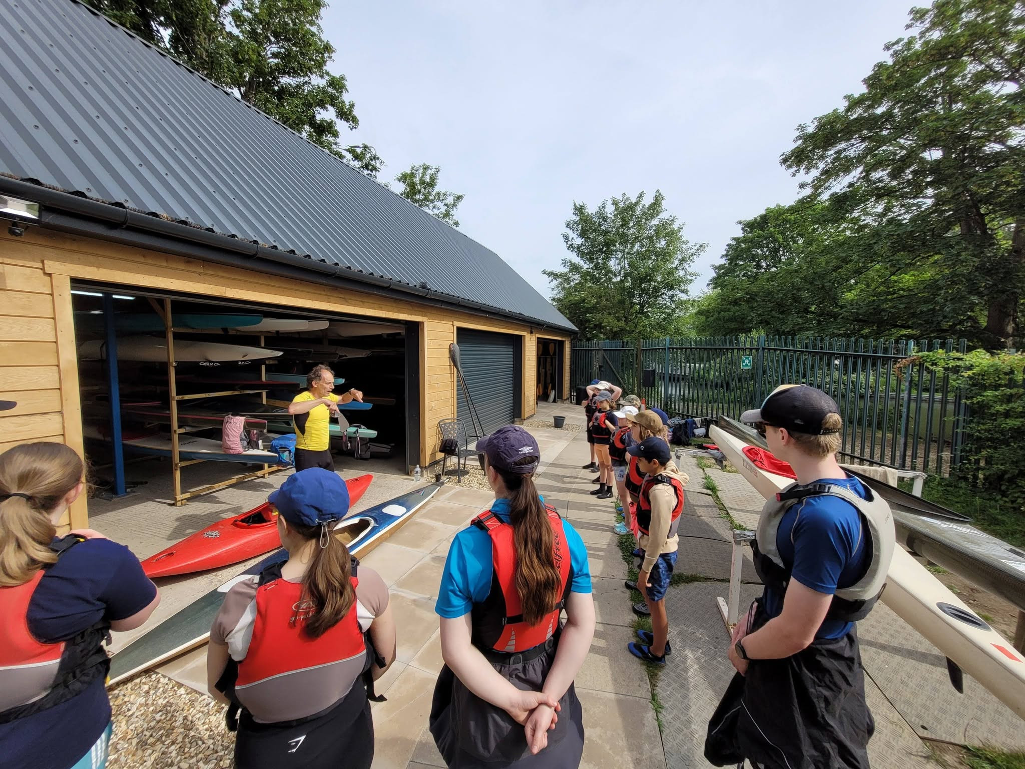 Photo showing boating instructor speaking to a group of cadets