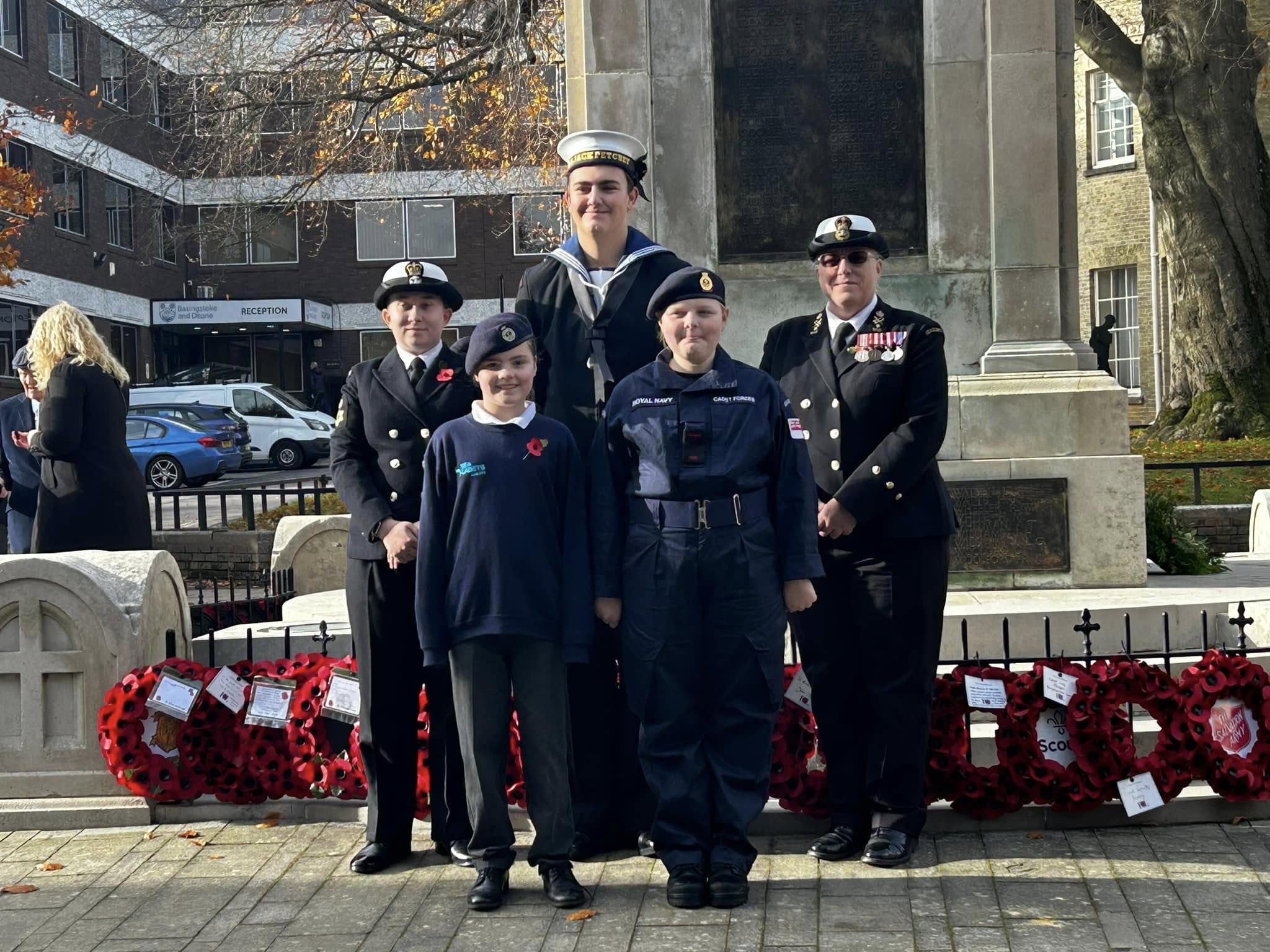 Photo showing cadts and adult volunteers standing together for Remembrance