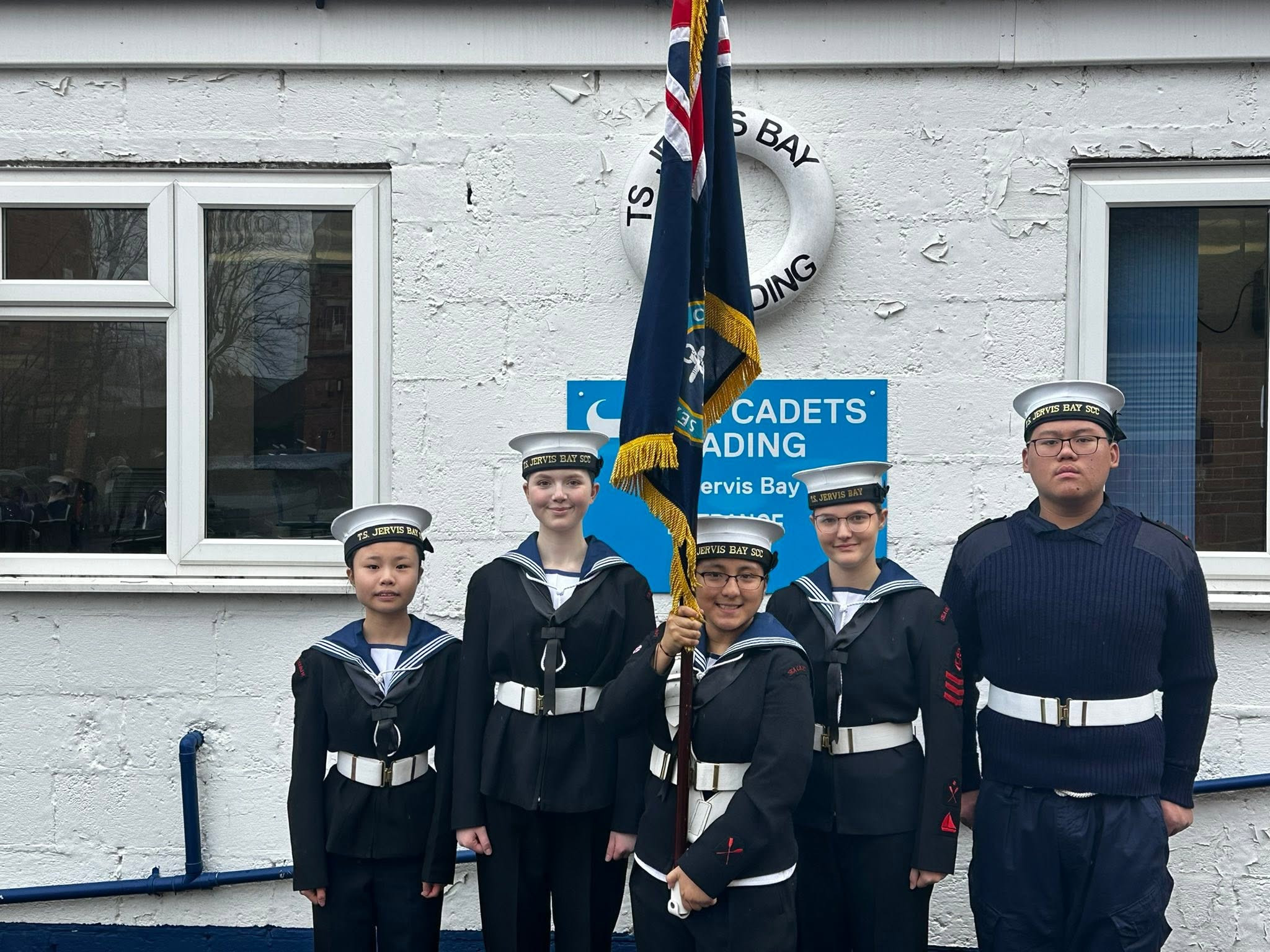 Photo showing cadets smiling posing for a photo outside Reading Sea Cadet Unit.