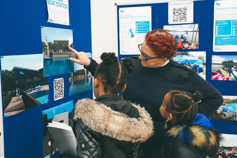Young people viewing a display board